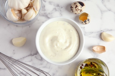 Photo of Flat lay composition with garlic sauce on marble background