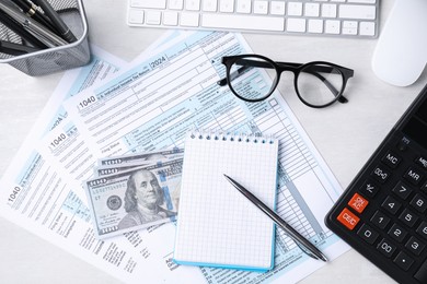 Photo of Tax accounting. Flat lay composition with stationery and documents on light grey table