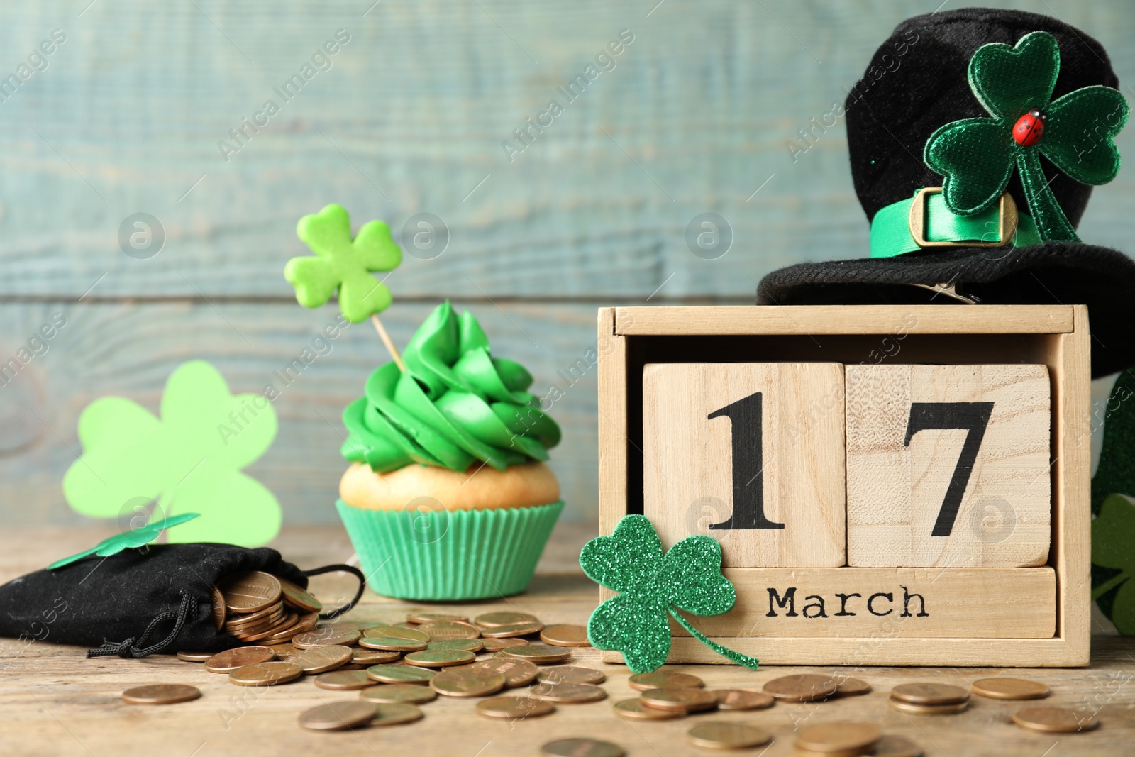 Photo of Composition with block calendar on wooden table. St. Patrick's Day celebration