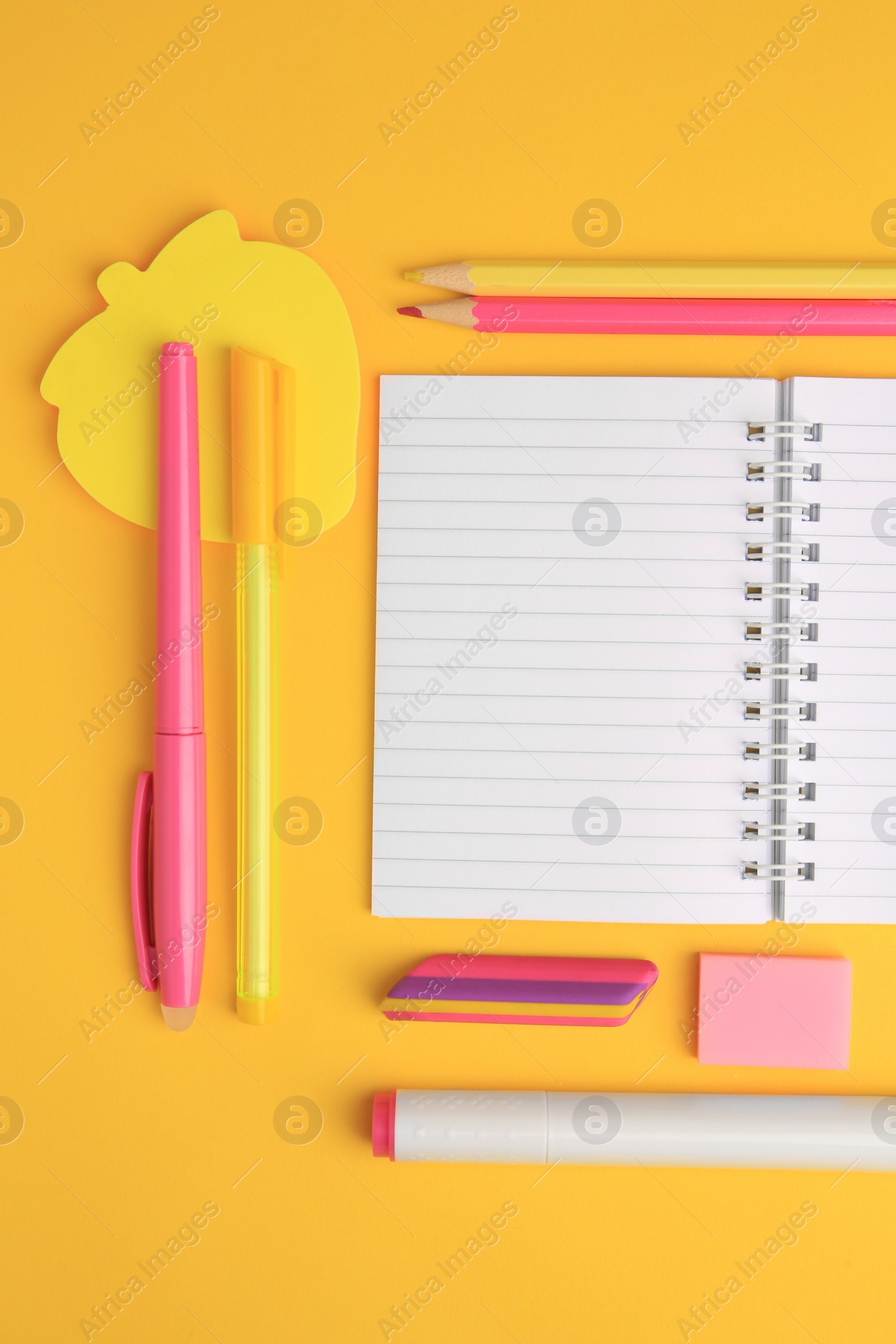 Photo of Flat lay composition with open notebook and different school stationery on yellow background, space for text. Back to school