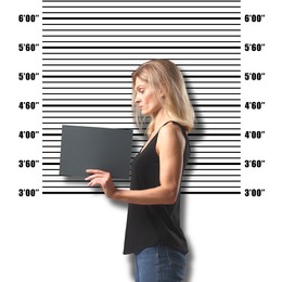 Image of Criminal mugshot. Arrested woman with blank card against height chart