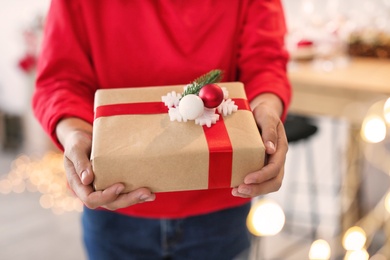 Woman holding Christmas gift box, closeup