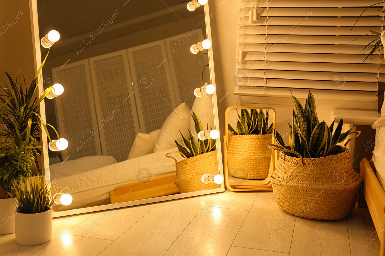 Photo of Stylish mirror with light bulbs in dark room. Interior design