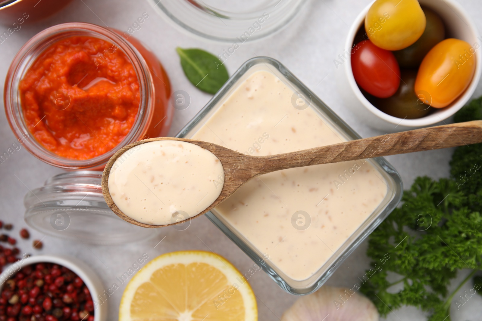 Photo of Different marinades and products on light table, flat lay