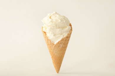 Photo of Delicious ice cream in waffle cone on white background