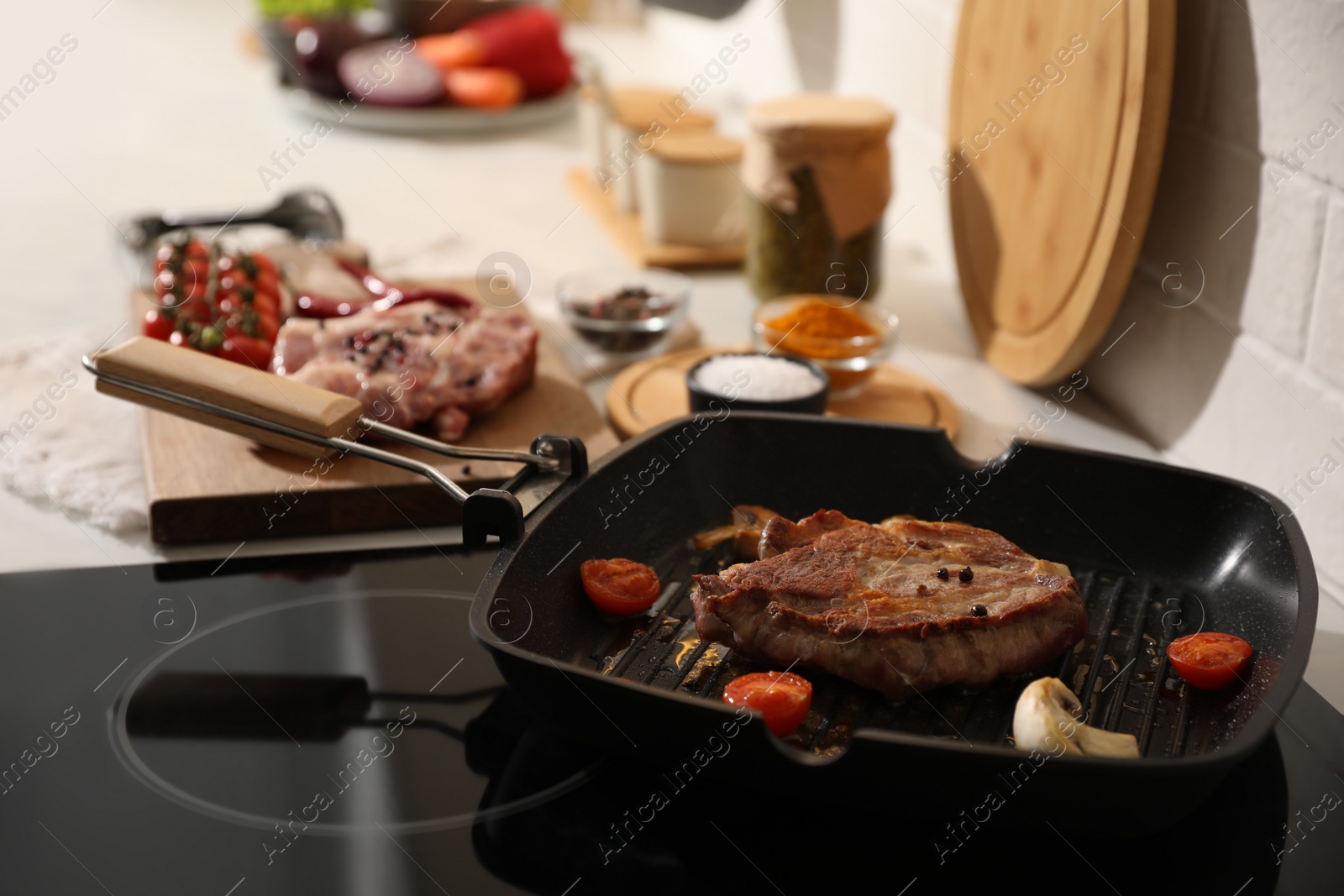 Photo of Frying pan with fresh raw meat and vegetables on stove