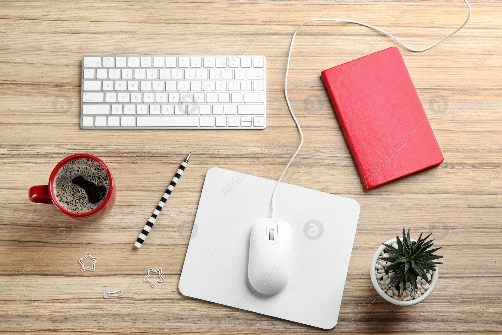 Photo of Flat lay composition with mouse and cup of coffee on wooden table