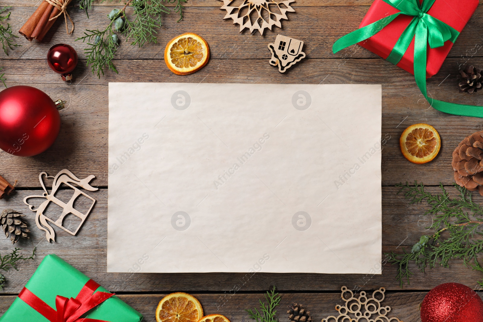 Photo of Blank paper with space for text and Christmas decor on wooden background, flat lay. Letter to Santa Claus