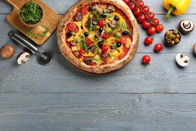 Photo of Flat lay composition with vegetable pizza on light grey wooden table. Space for text