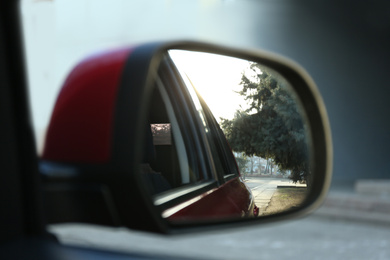 Side rear view mirror of modern car outdoors, closeup