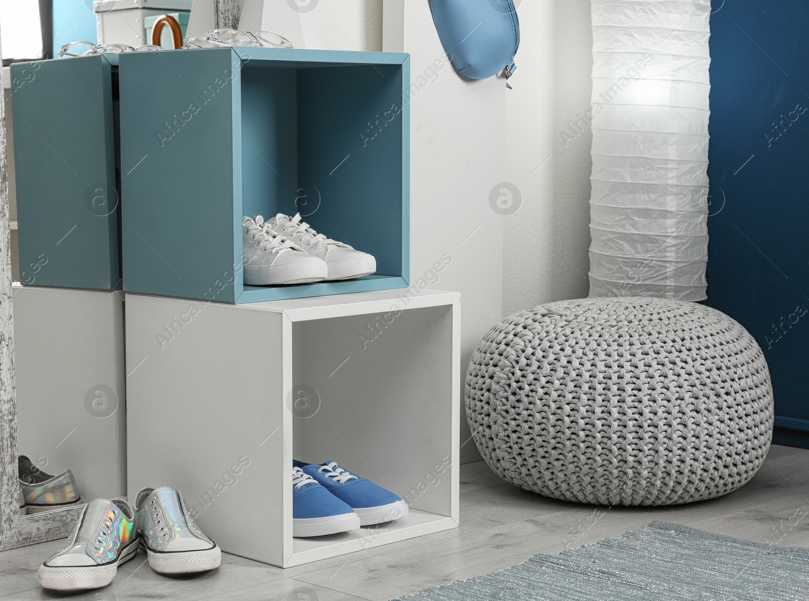 Photo of Stylish hallway interior with shoe rack near light wall