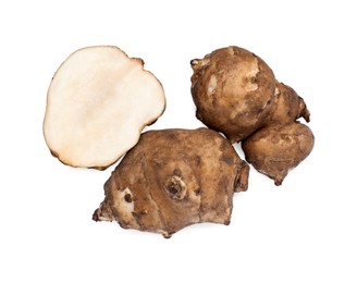 Photo of Whole and cut Jerusalem artichokes isolated on white, top view