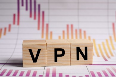 Photo of Acronym VPN (Virtual Private Network) made of wooden cubes on document