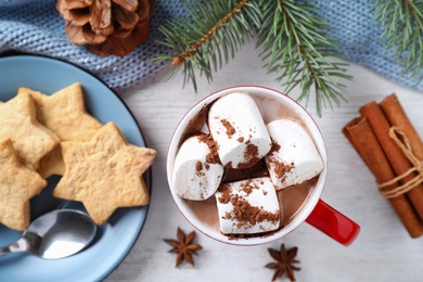 Photo of Flat lay composition of tasty cocoa with marshmallows on white wooden table