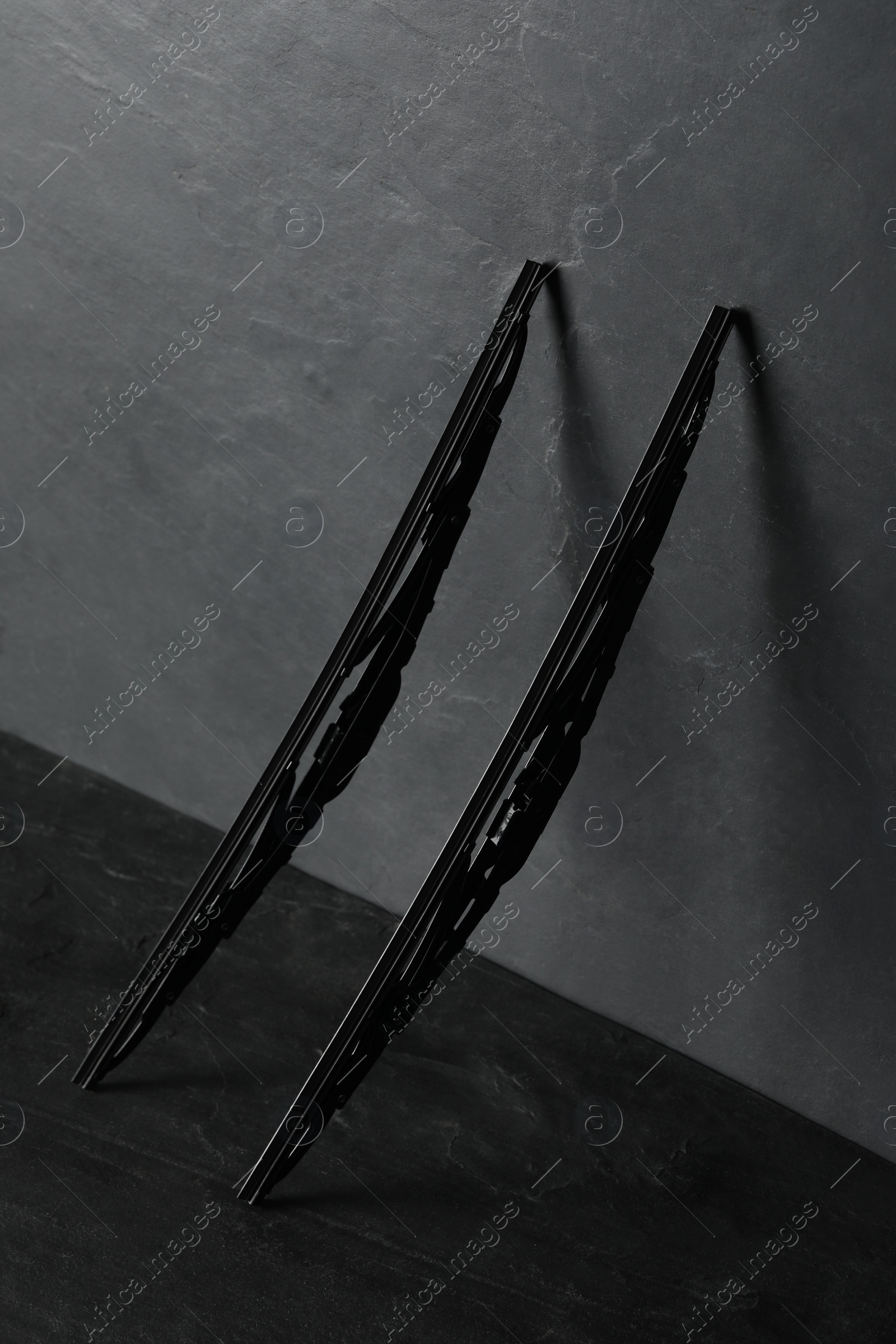 Photo of Car windshield wipers on black slate table