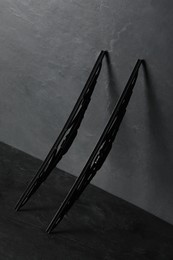 Car windshield wipers on black slate table