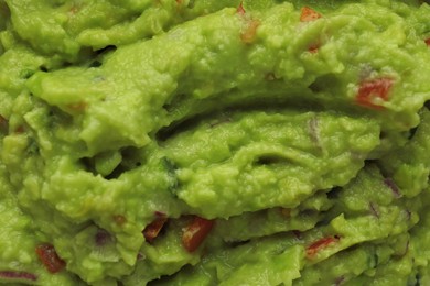 Delicious fresh guacamole as background, top view
