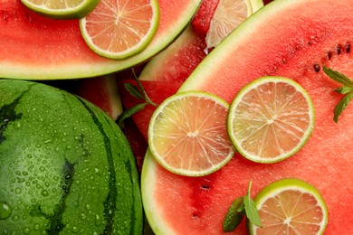 Photo of Juicy watermelon with lime and mint as background, top view