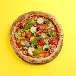 Delicious hot vegetable pizza on yellow background, top view