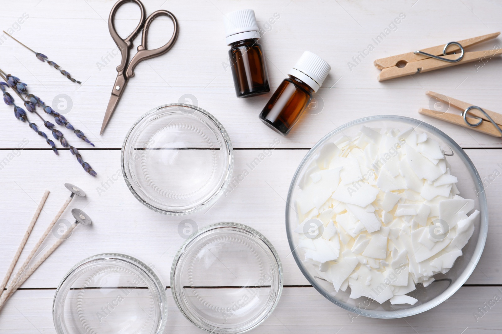 Photo of Flat lay composition with ingredients for homemade candles on white wooden background