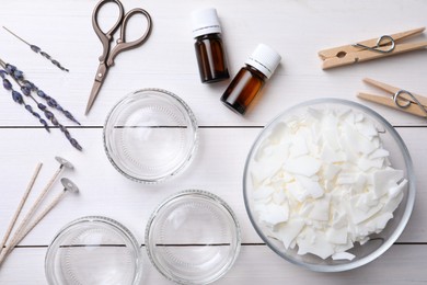 Photo of Flat lay composition with ingredients for homemade candles on white wooden background