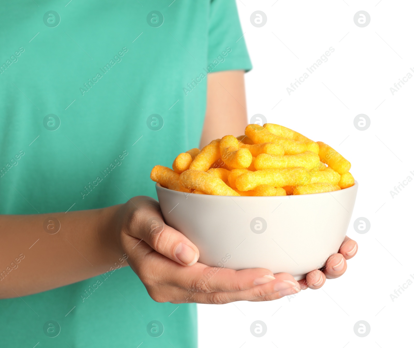 Photo of Woman holding bowl of crunchy cheesy corn sticks on white background, closeup