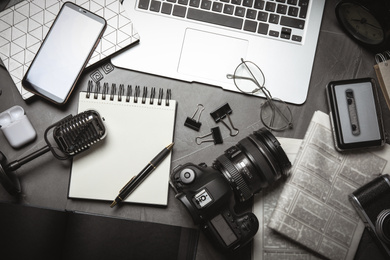Image of Flat lay composition with equipment for journalist on grey table