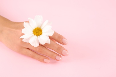 Photo of Closeup view of woman with flower on color background, space for text. Spa treatment