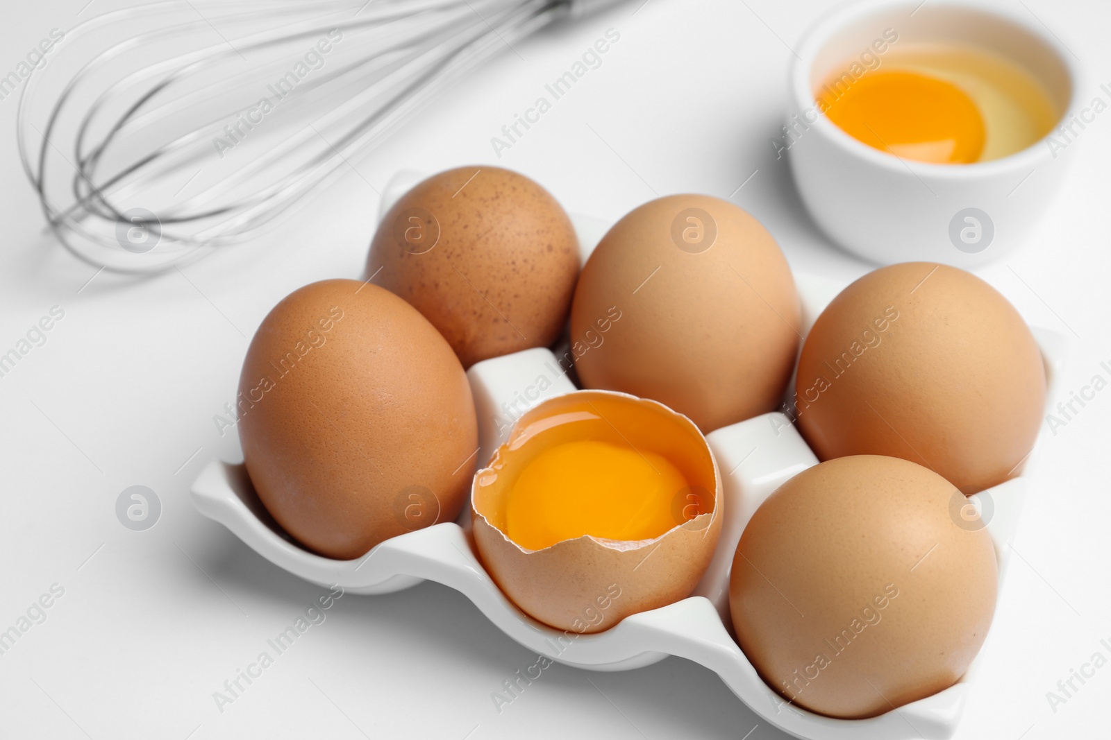 Photo of Brown chicken eggs on white background, closeup