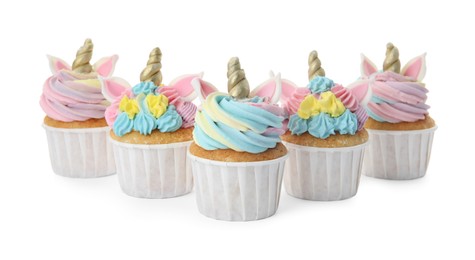 Photo of Many cute sweet unicorn cupcakes on white background