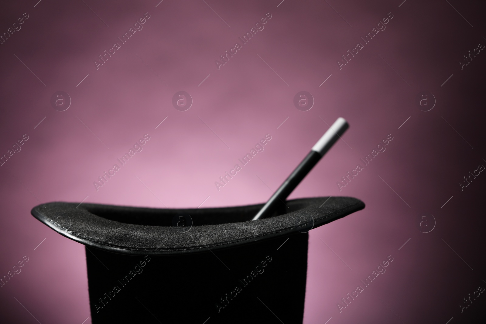 Photo of Magician's hat and wand on dark background