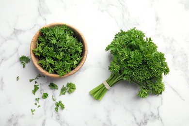 Photo of Flat lay composition with fresh green parsley on marble table