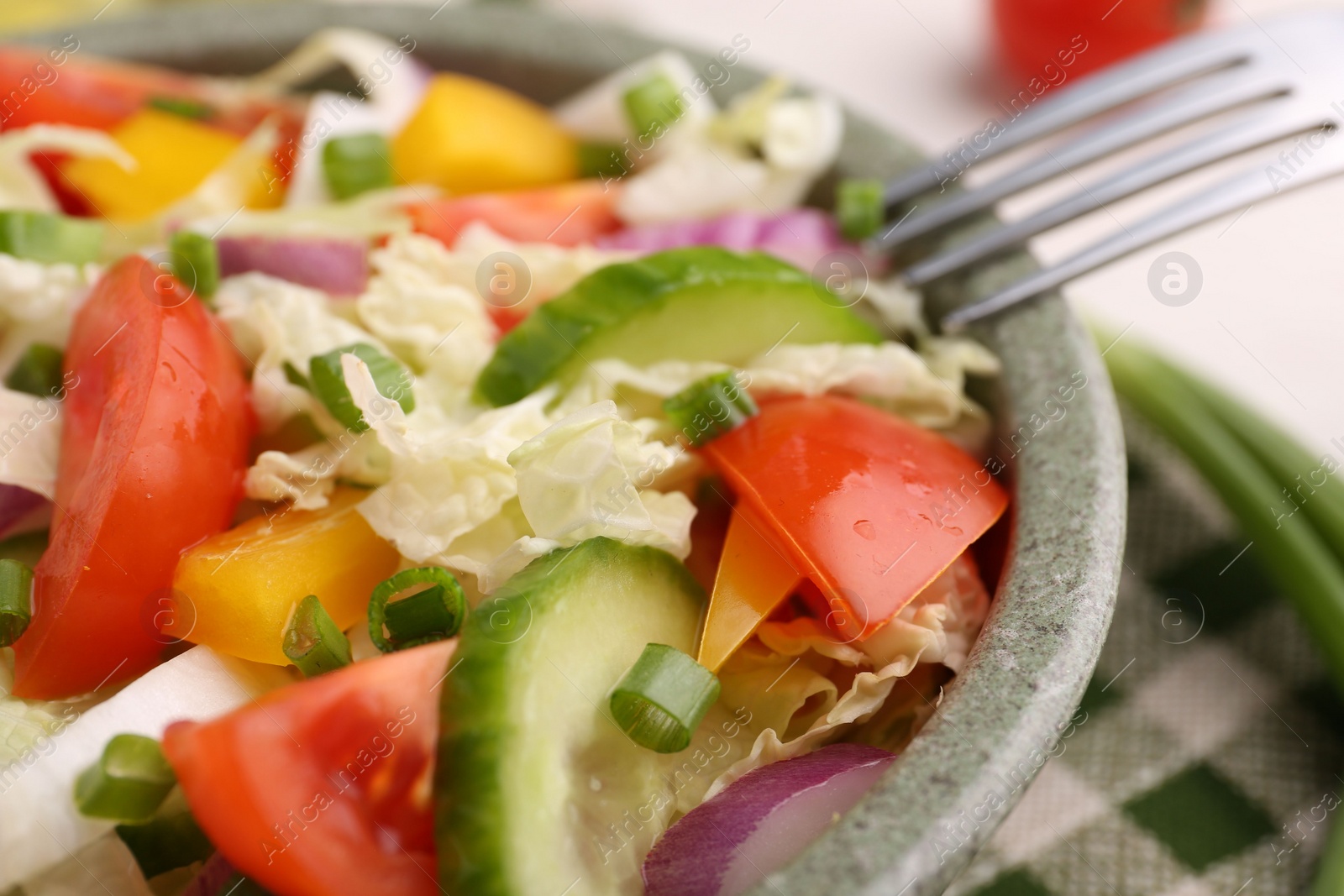 Photo of Tasty salad with Chinese cabbage in bowl on table, closeup