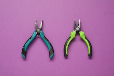 Two pliers on purple background, flat lay