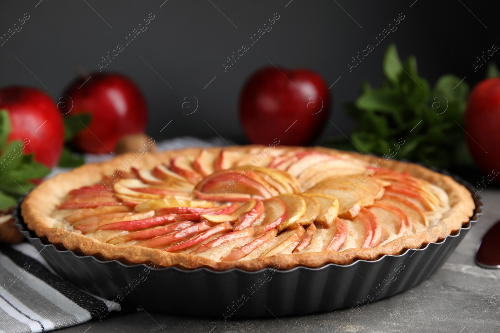 Photo of Delicious homemade apple tart on grey table