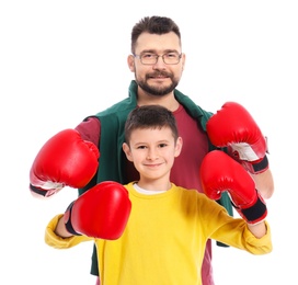 Photo of Little boy and his dad in boxing gloves on white background