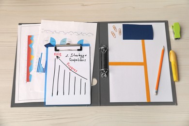 Business process planning and optimization. Documents with different types of graphs and stationery on wooden table, above view