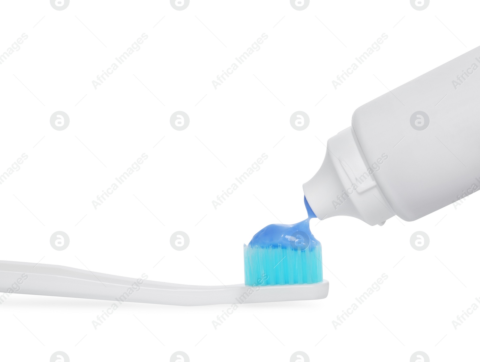 Photo of Applying paste on toothbrush against white background