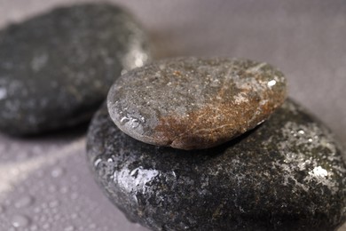 Photo of Wet spa stones on grey background, closeup