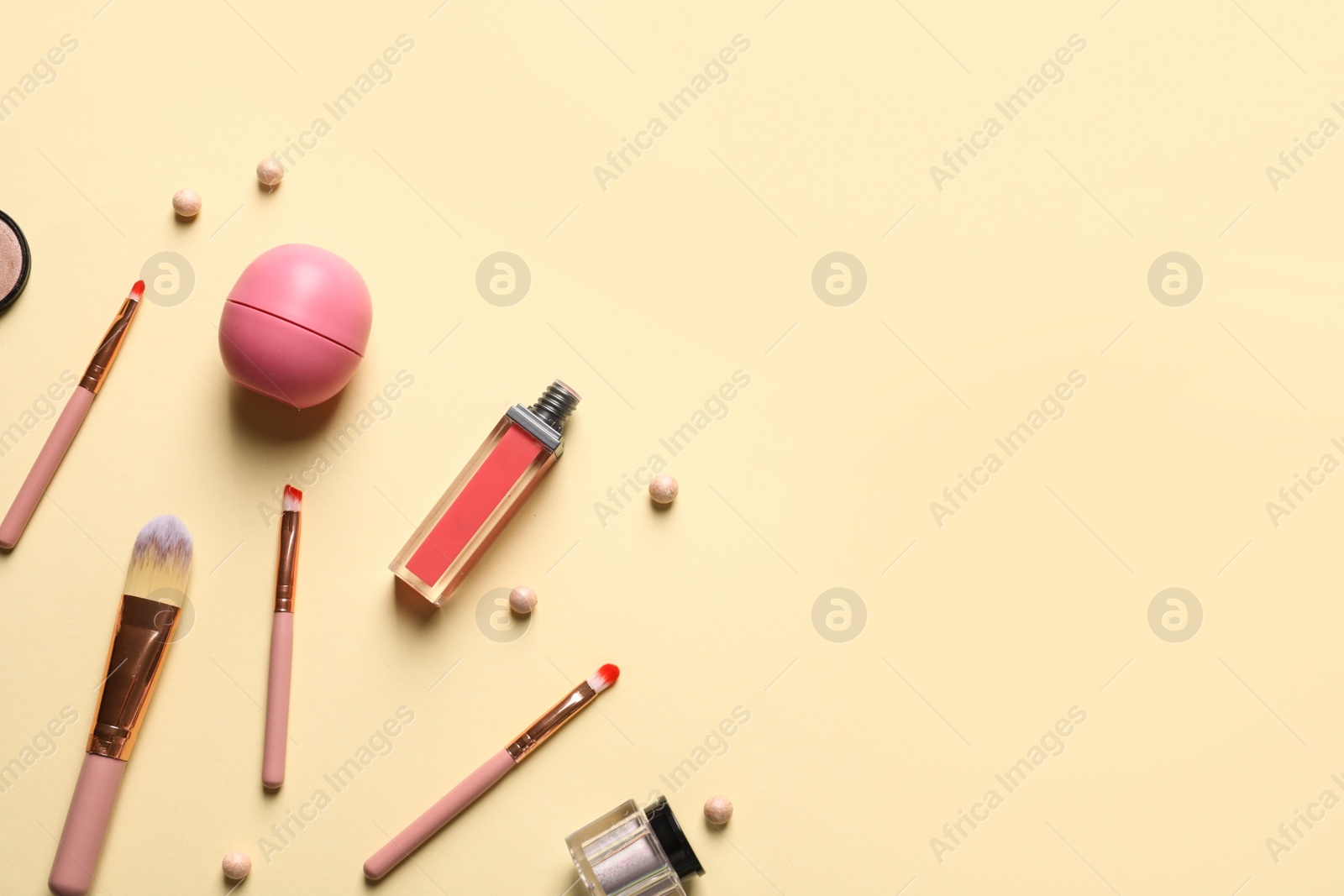 Photo of Flat lay composition with makeup brushes on beige background. Space for text