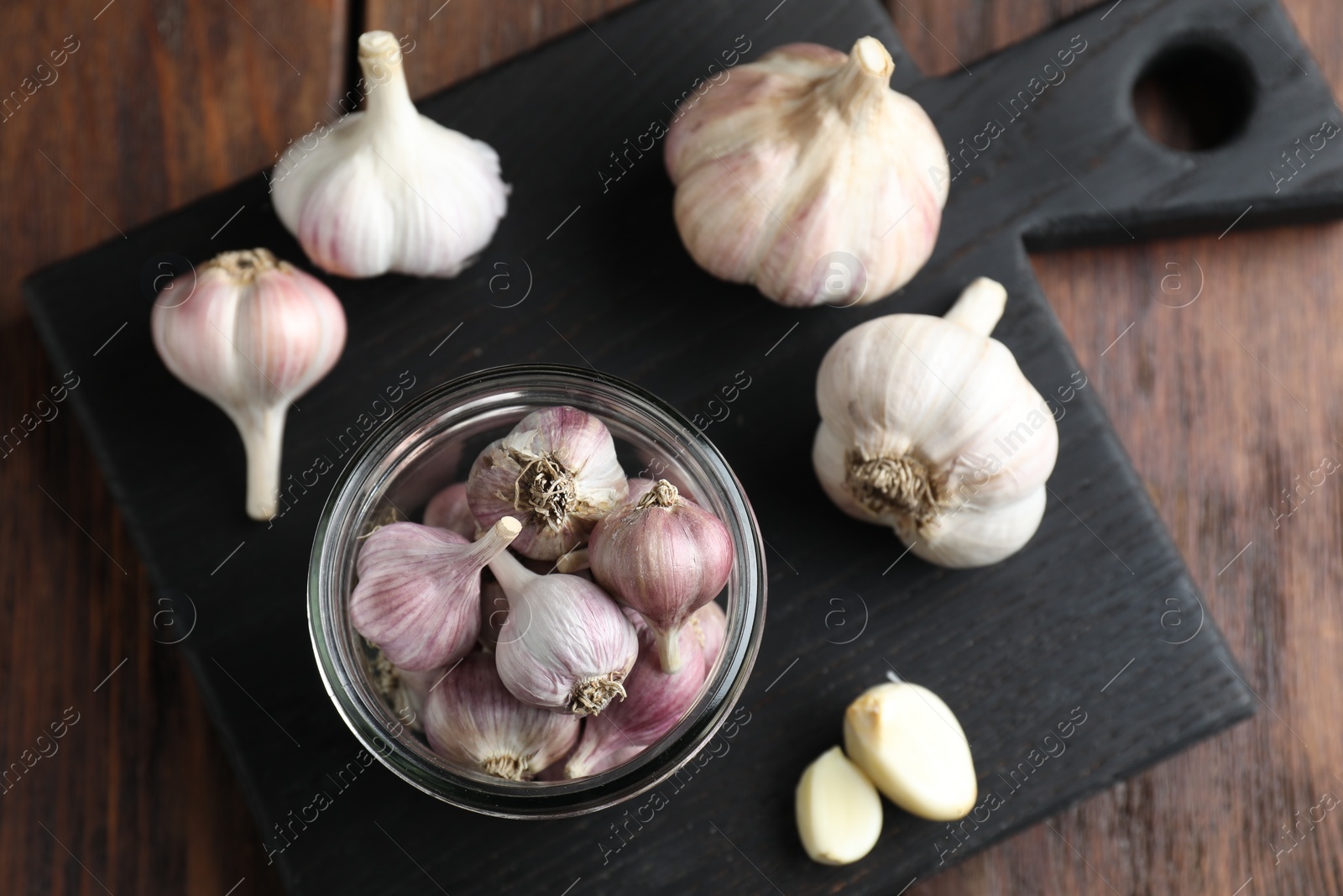 Photo of Many fresh garlic bulbs on wooden table, top view