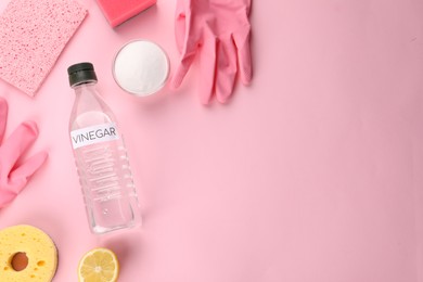 Photo of Eco friendly natural cleaners. Flat lay composition with bottle of vinegar on pink background, space for text