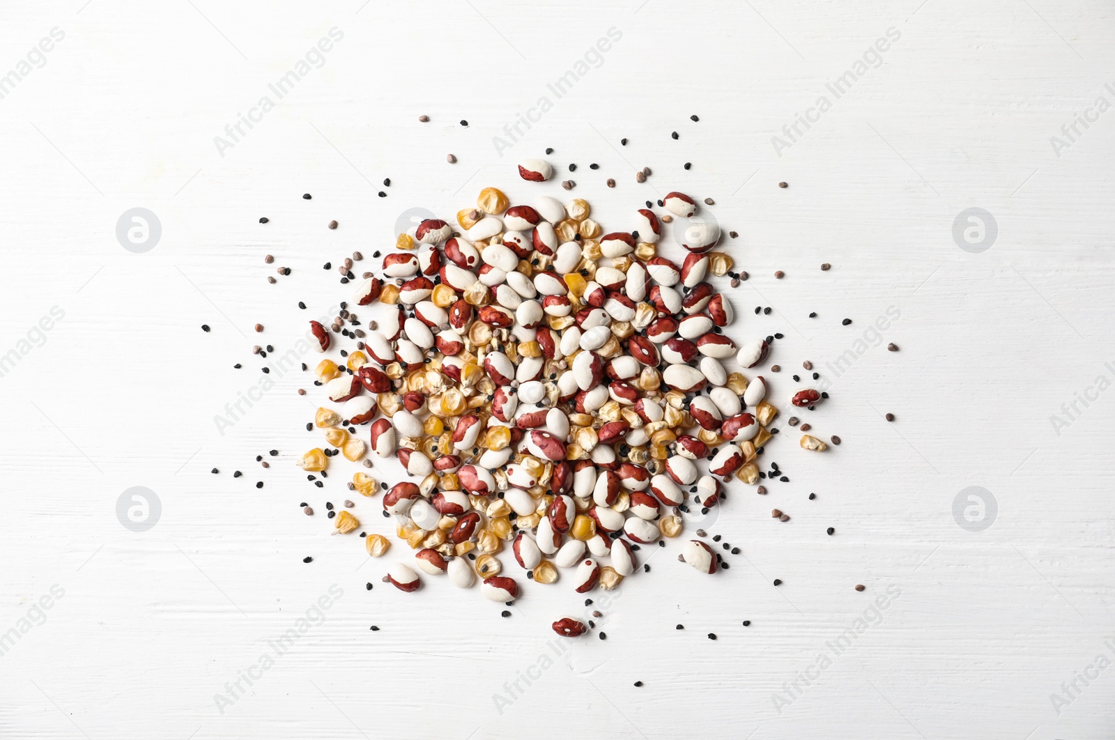 Photo of Mixed vegetable seeds on white wooden background, flat lay