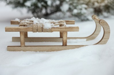 Photo of Beautiful decorative wooden sleigh on snow outdoors