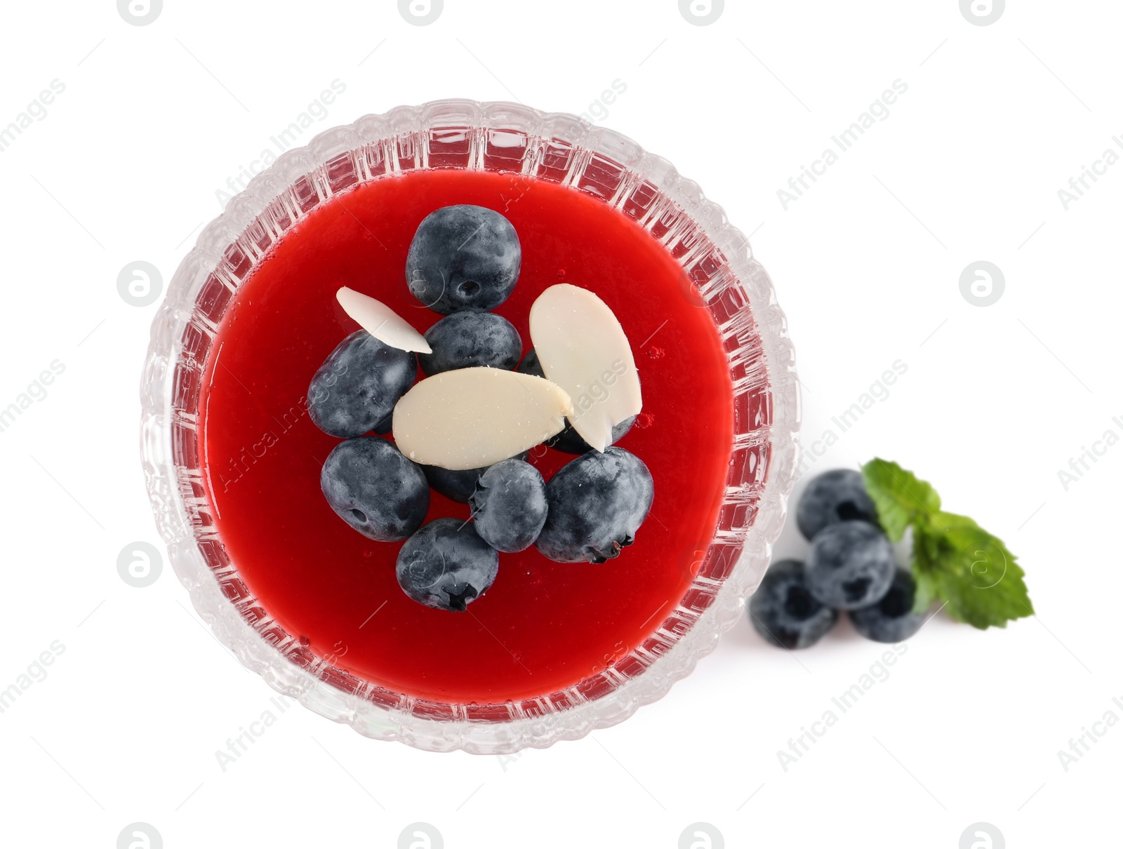 Photo of Delicious fruit jelly with fresh blueberries and almond flakes on white background, top view