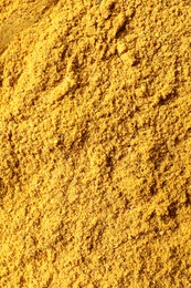 Photo of Dry curry powder as background, top view