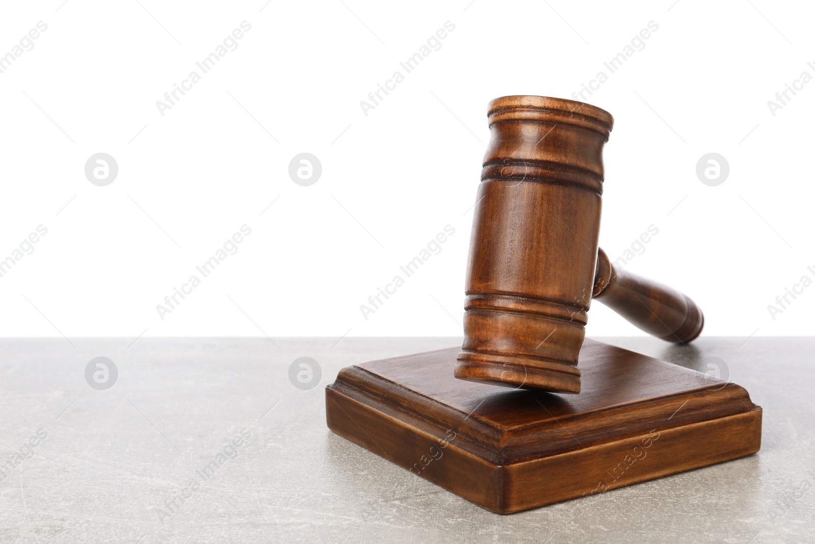 Photo of Wooden gavel on light table against white background. Space for text