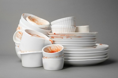 Photo of Set of dirty dishes on grey background