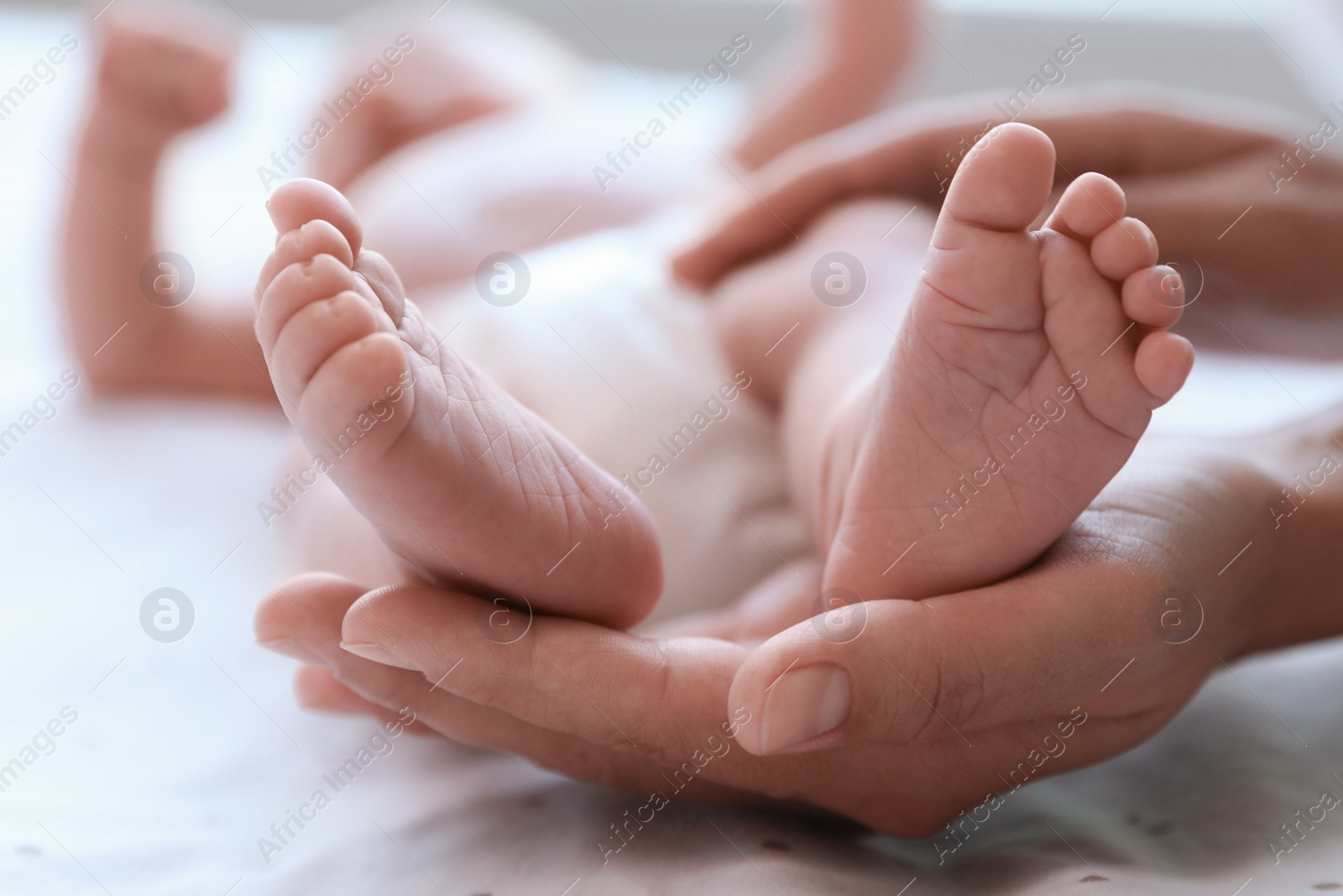 Photo of Mother and her newborn baby on bed, closeup