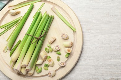 Photo of Fresh lemongrass on white wooden table, flat lay. Space for text